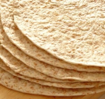 Easy Vegan Whole Wheat Tortillas Recipe - these soft whole wheat tortillas take just 1 hour to make and only require three simple ingredients! They're pretty healthy and much better for you than the ones you get in the store. I'll never buy tortillas ever again!