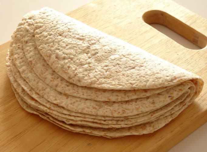 Easy Vegan Whole Wheat Tortillas Recipe - these soft whole wheat tortillas take just 1 hour to make and only require three simple ingredients! They're pretty healthy and much better for you than the ones you get in the store. I'll never buy tortillas ever again!