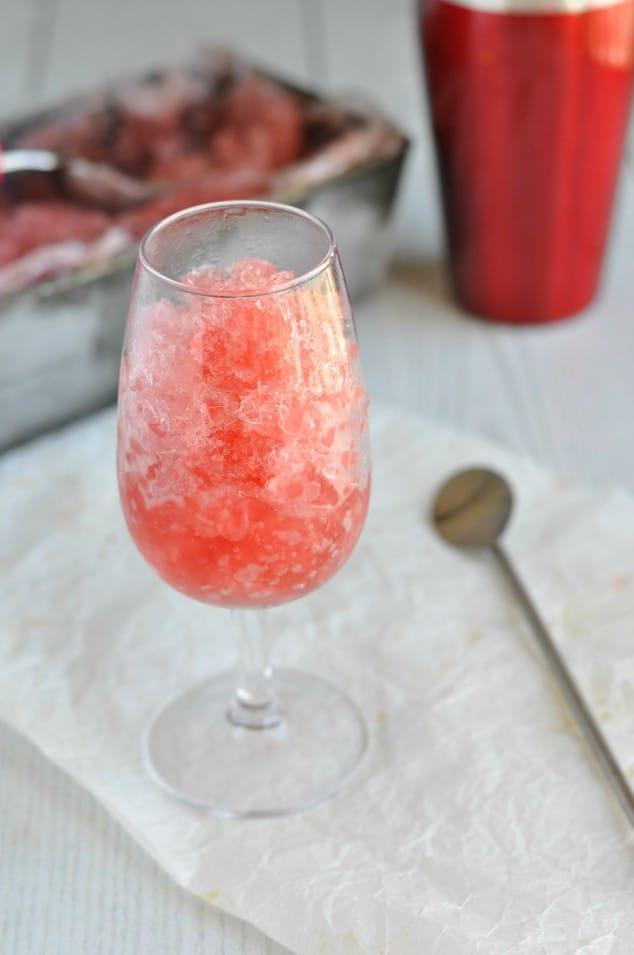 A glass of red Christmas cranberry vodka slush