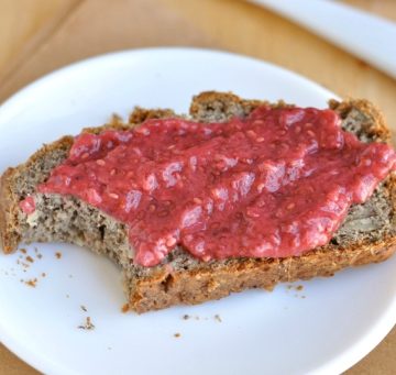 Strawberry chia seed jam on toast surrounded by crumbs