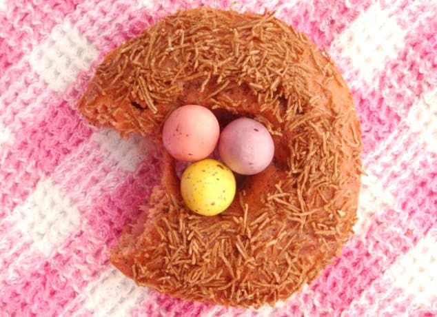 Healthy Baked Donuts for Easter. Cute Easter idea for strawberry donuts topped with All Bran and chocolate eggs to look like a bird nest.