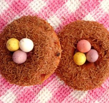 Healthy Baked Donuts for Easter. Cute Easter idea for strawberry donuts topped with All Bran and chocolate eggs to look like a bird nest.