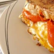 Veggie #Breakfast Grilled Cheese Recipe - The ULTIMATE gourmet grilled cheese you can make for breakfast, brunch, lunch or dinner. Loaded with juicy mushrooms, tomatoes, a crispy fried egg and loads of melted cheese. Delish! | www.happyhealthymotivated.com