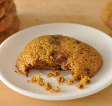 A Healthy Pumpkin Cookie with a bite taken out of it on a small white plate