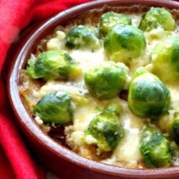 Lighter Brussels Sprouts Gratin Recipe - looking for a healthy Christmas side dish to help keep it light this year? These brussels sprouts au gratin is perfect! Crispy pan-fried brussels sprouts baked with ooey-gooey melted cheese. Heaven! | www.happyhealthymotivated.com