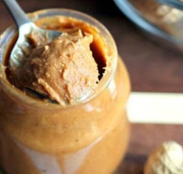 A jar filled with peanut butter and a spoon