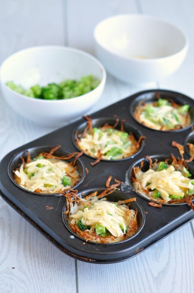 Unbaked Healthy hash brown egg cups in a black muffin tin