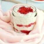 A bowl of Strawberry Cheesecake Overnight Oats wrapped in a pink scarf