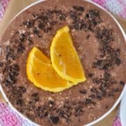 A bowl of rich and creamy chocolate orange overnight oats topped with slices of orange