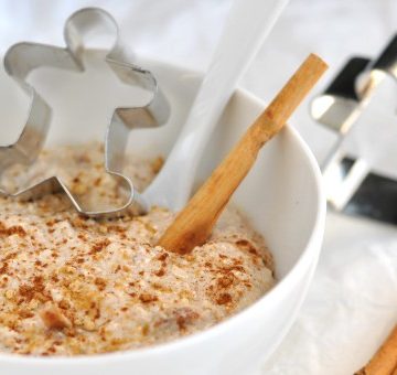 A bowl of Healthy Gingerbread Overnight Oats with a gingerbread man cookie cutter
