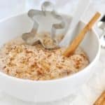 A bowl of Healthy Gingerbread Overnight Oats with a cinnamon stick and ground cinnamon