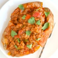 Healthy baked sweet potato sprinkled with fresh coriander