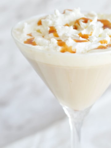 Close-up shot of the whipped cream and caramel drizzle on a winter cocktail.