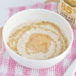 A bowl of peanut butter overnight oats drizzled with honey