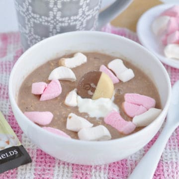 A bowl of hot chocolate overnight oats with marshmallows.